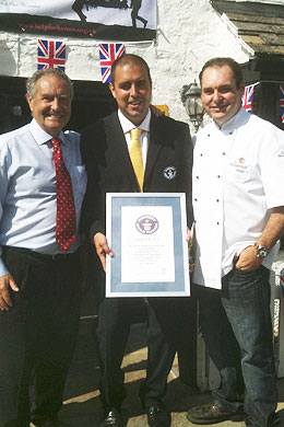 Photo of David and Lewis Moss with the official Guinness adjudicator Rob Molloy
